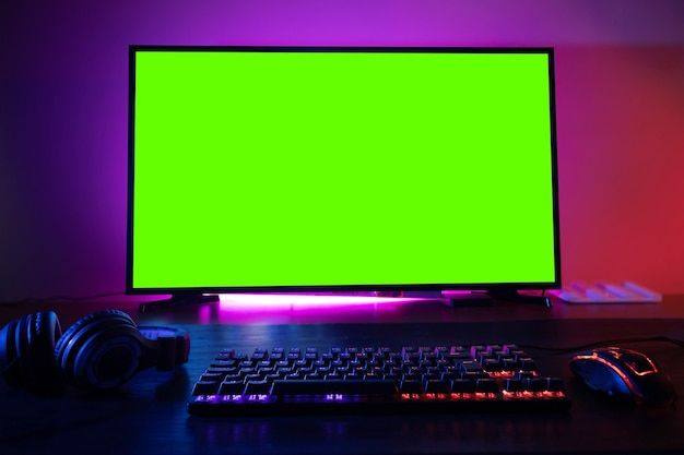 Premium Photo | Green screen monitor with powerful personal computer for cyber sports gamer at home table.